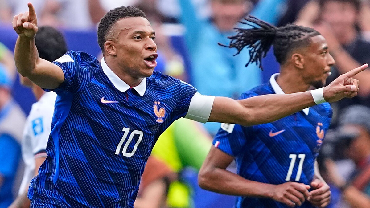 Mbappe double sends France into last 32 after weather-hit win over Iraq